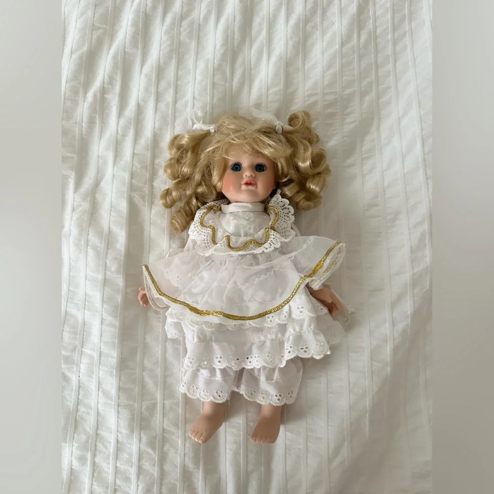 Victorian style porcelain doll with curly blond hair